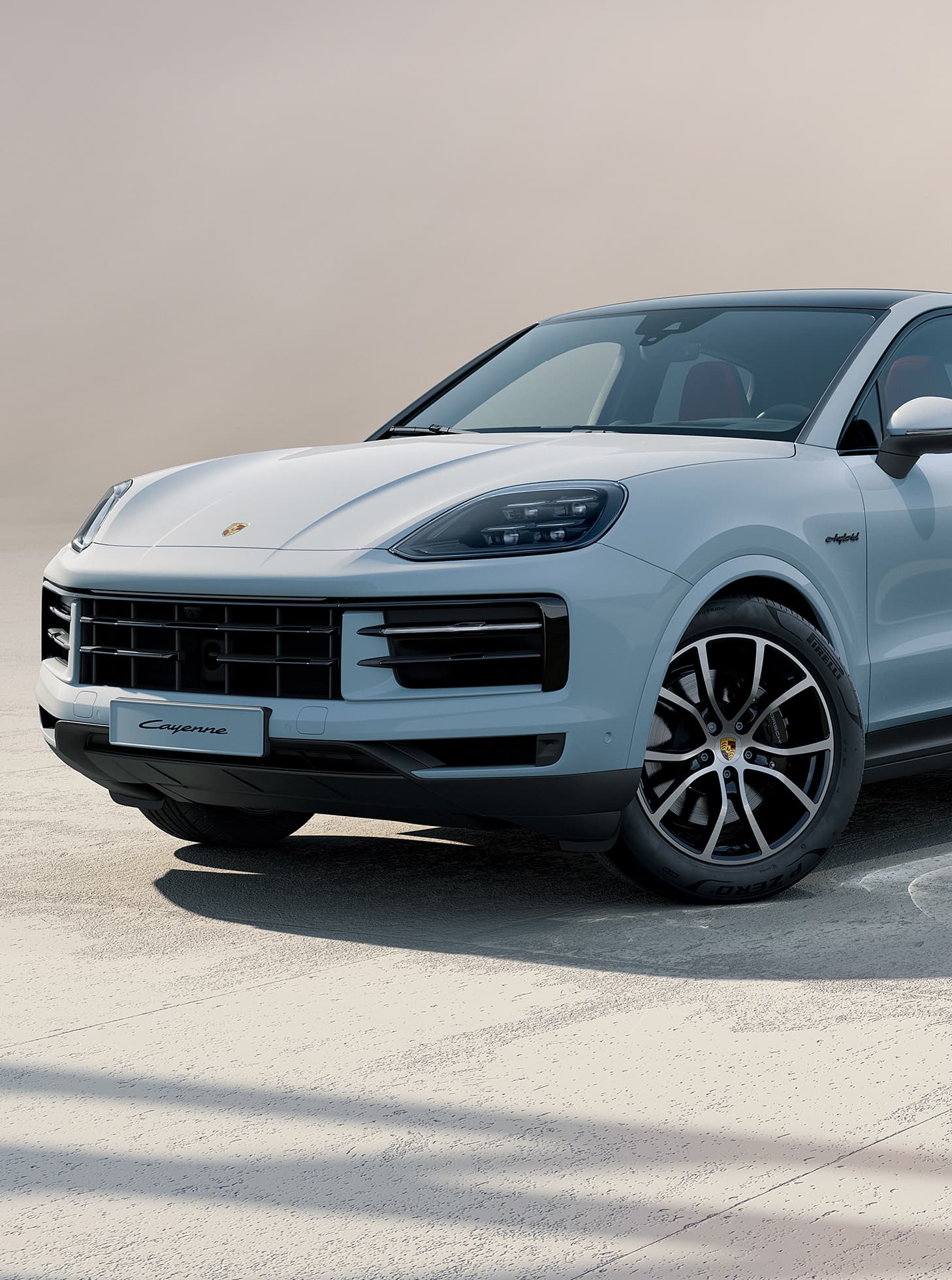 A Porsche Cayenne driving on an open road.
